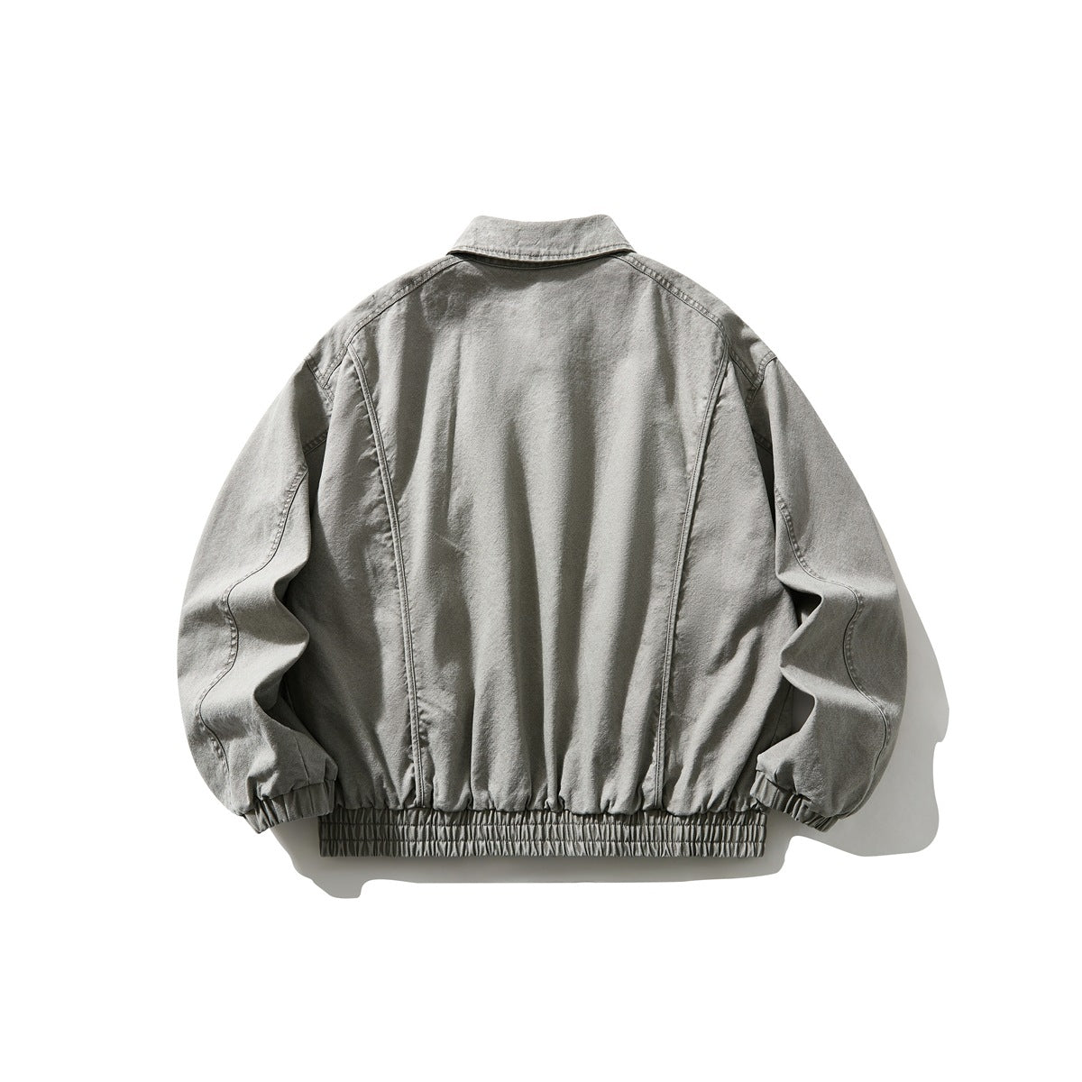 Back view of gray washed collared jacket with seam details, elastic cuffs and ribbed hem band