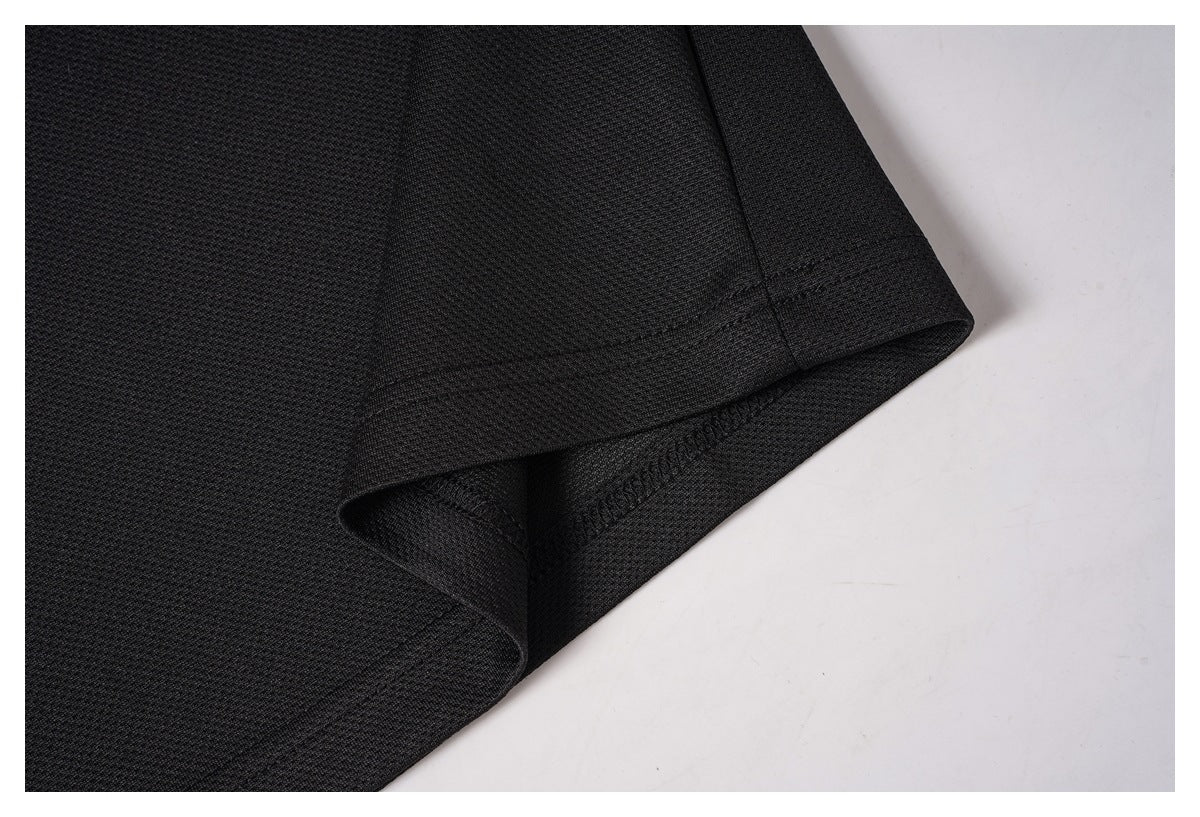 Close-up of the black shirt's bottom hem and stitching.