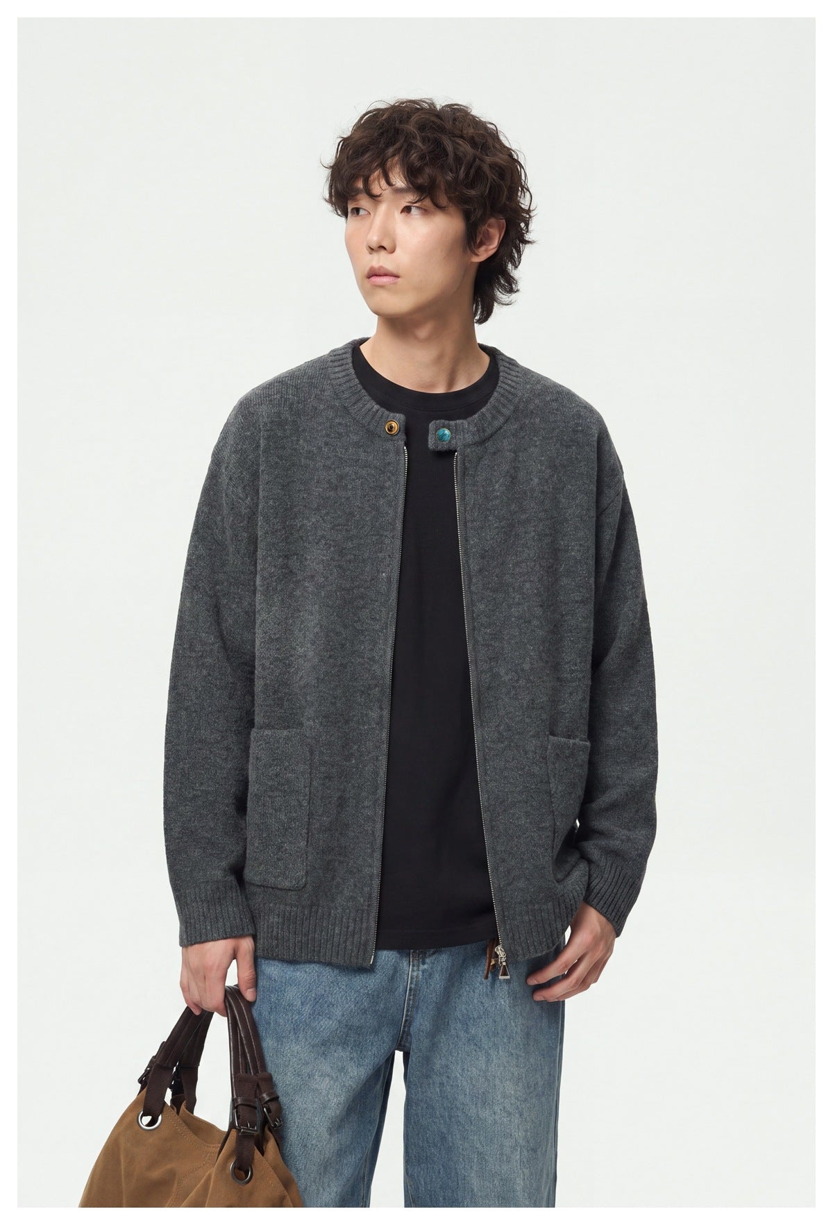 Model wearing an open charcoal gray cardigan with a front zipper, ribbed edges, and two patch pockets.