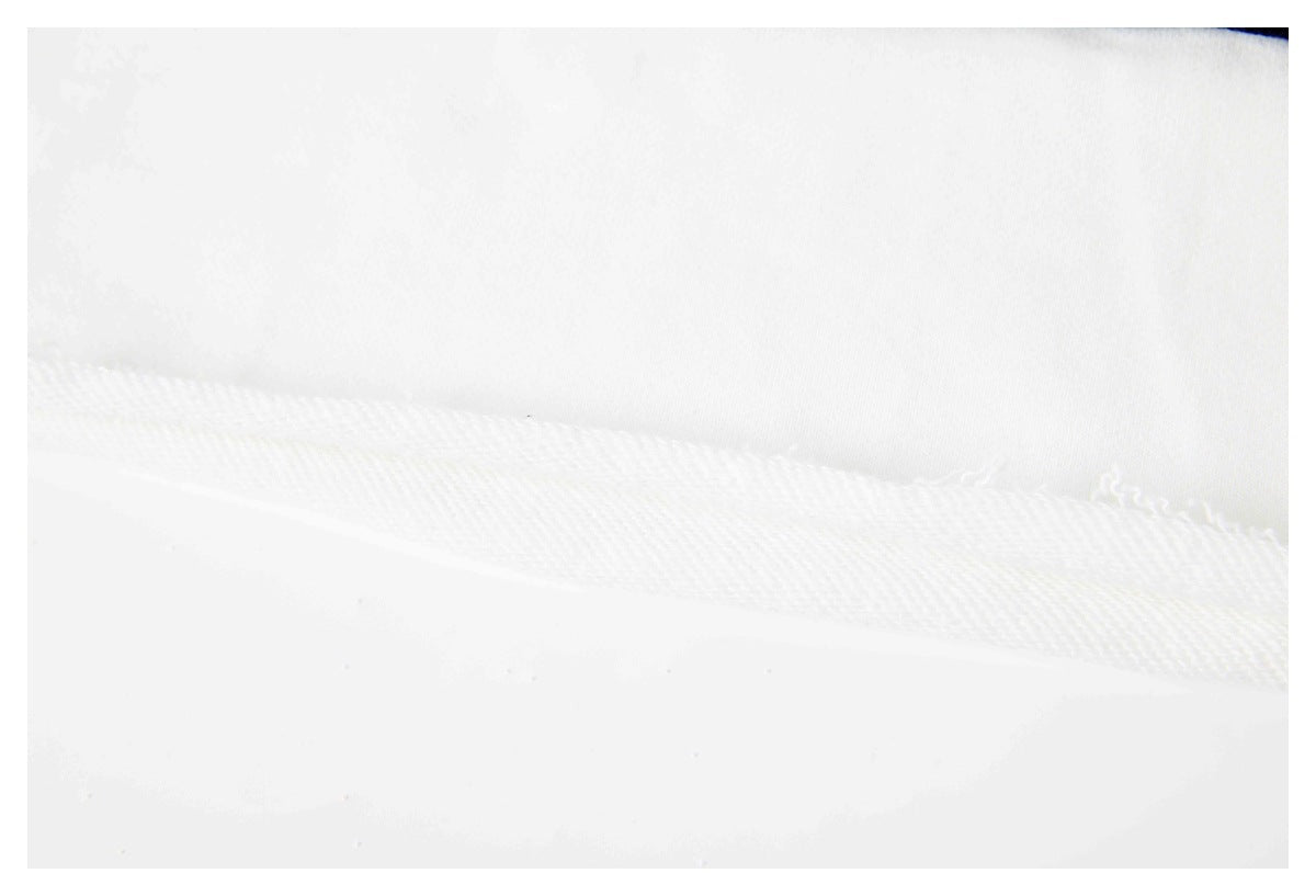 Close-up of a white garment seam and stitching, with a small navy section at the edge.