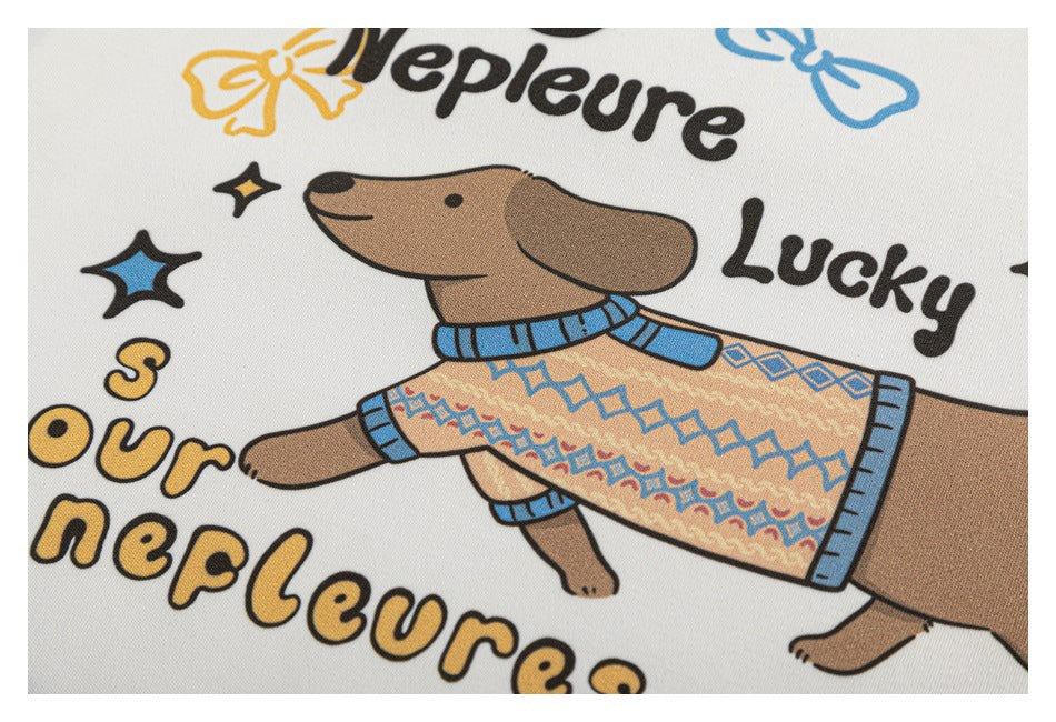 Close-up of the shirt's colorful cartoon dog print, showing the dog in a patterned sweater and English lettering.