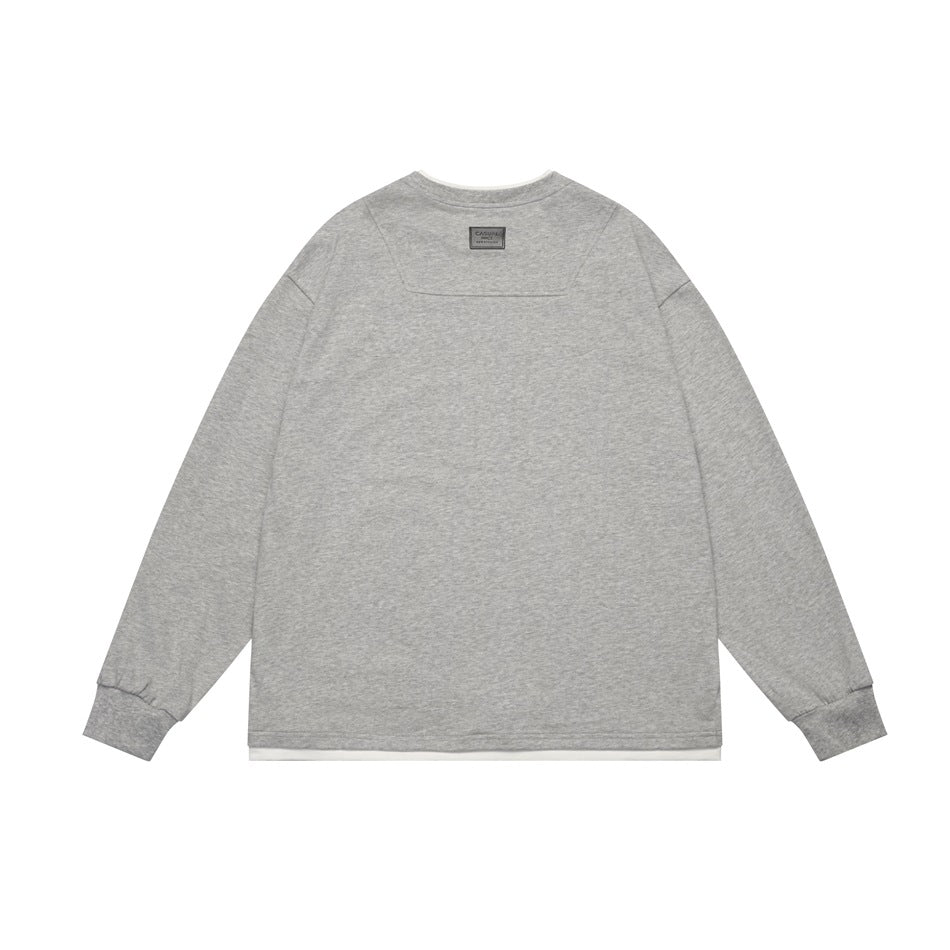Back view of a light heather gray long-sleeve crewneck top with ribbed cuffs and a narrow white layer at the hem.