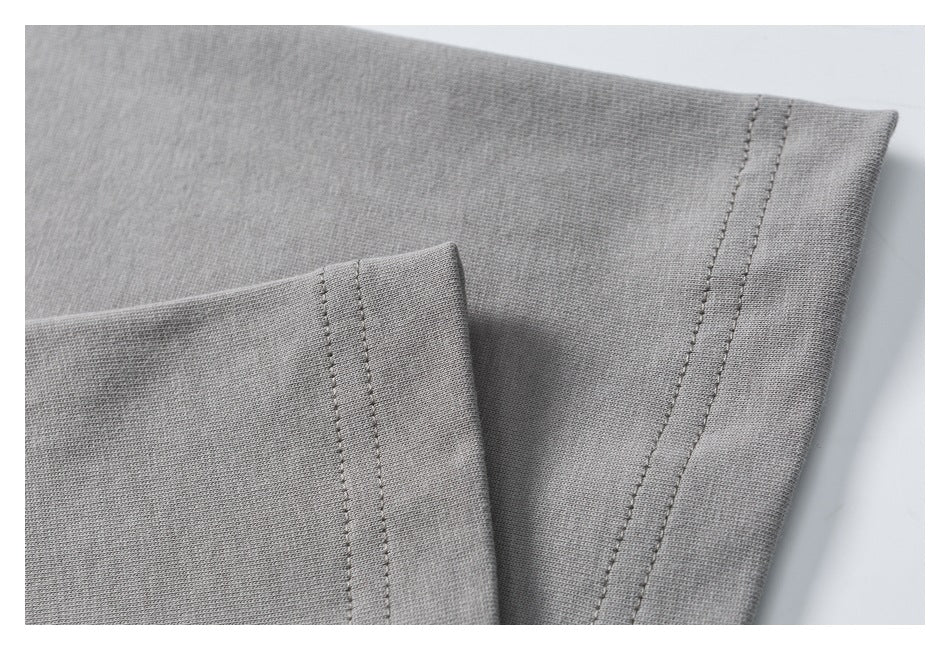 Close-up of gray fabric layers showing parallel rows of stitching along the edges.