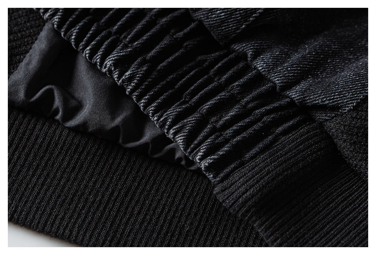 Close-up of gathered black fabric above a wide ribbed knit band.