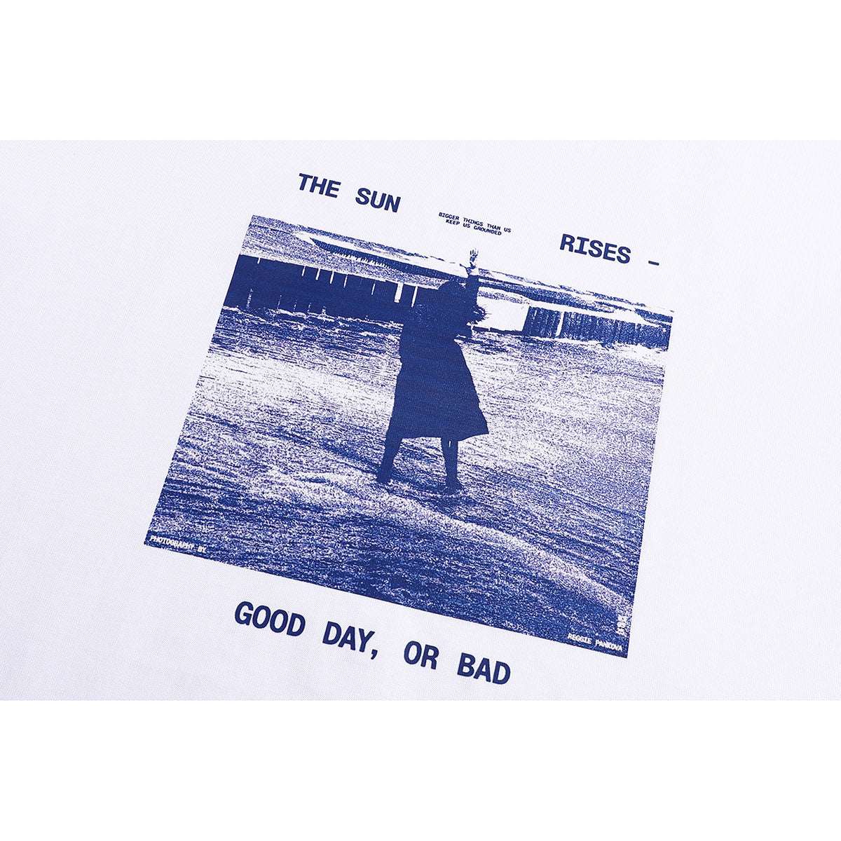 Close-up of the navy photo-style chest graphic and English lettering printed on a white T-shirt.