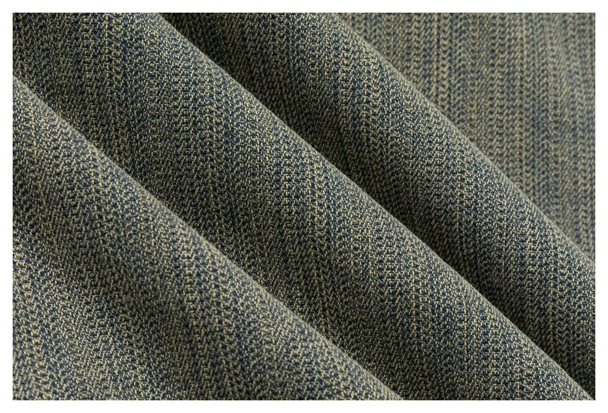 Close-up of dark charcoal and tan finely speckled woven fabric draped in soft folds.