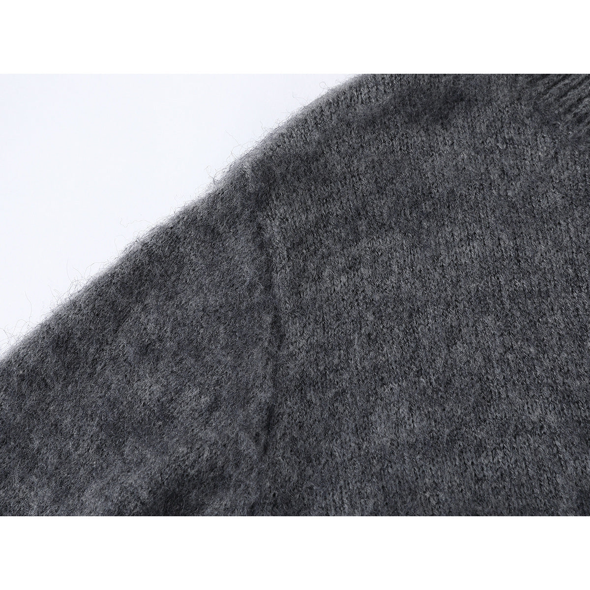 Close-up of the charcoal gray cardigan’s fuzzy knit texture and shoulder seam.