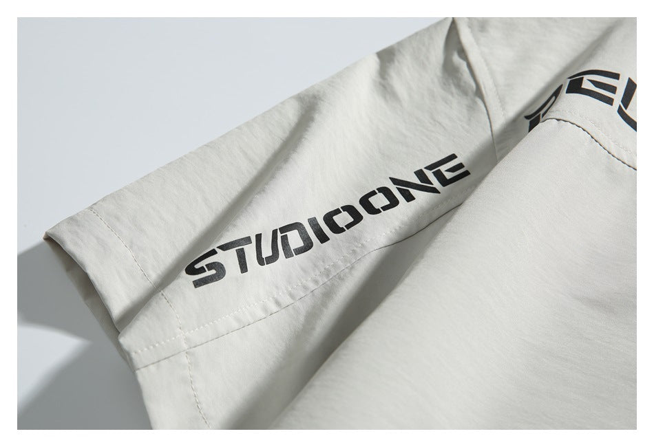 Close-up of an off-white shirt sleeve with bold black lettering printed along the seam.