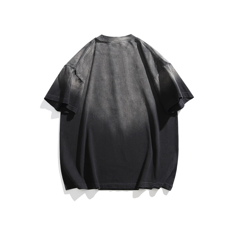 Back view of a loose charcoal-gray washed short-sleeve T-shirt on a white background.