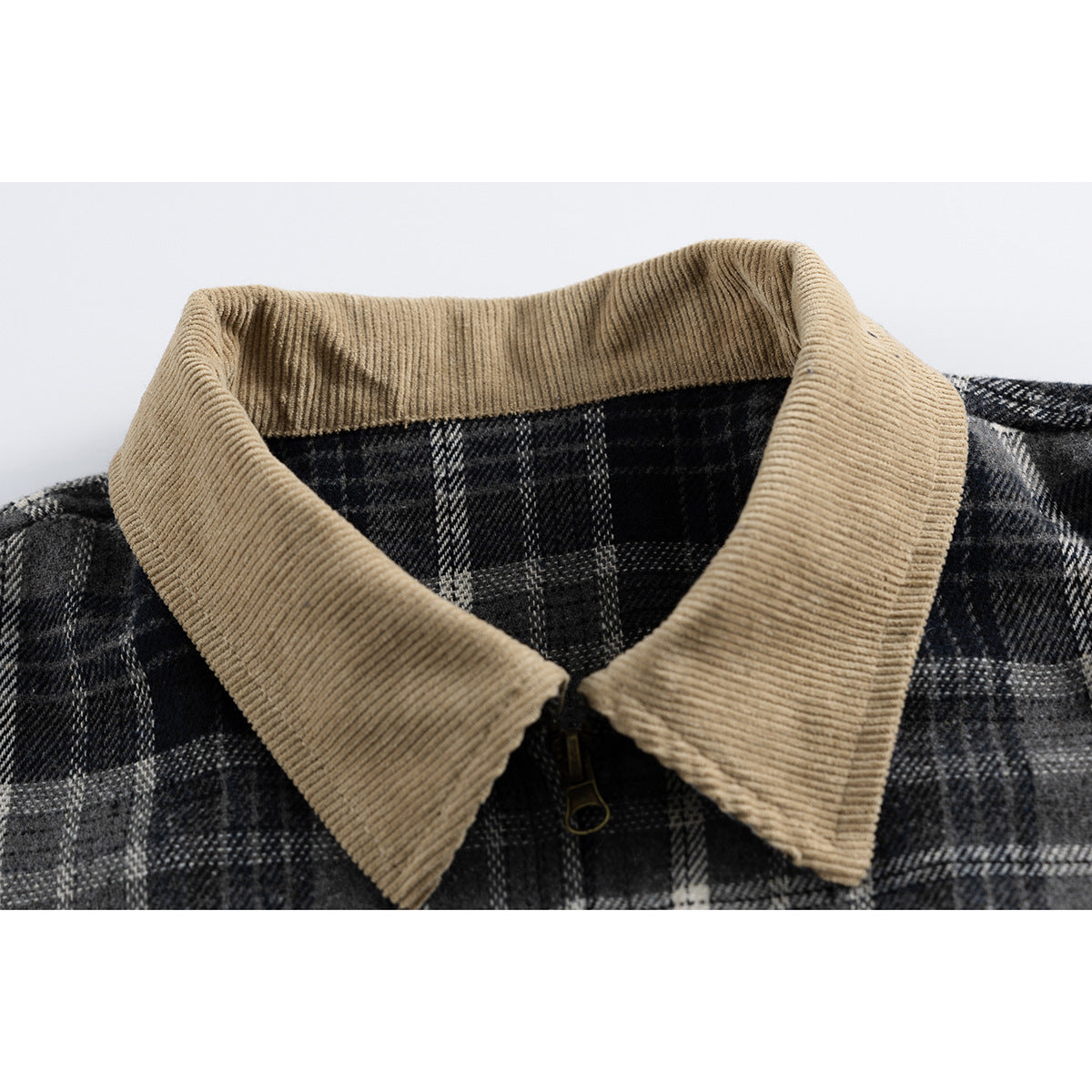 Close-up of a charcoal plaid jacket with a wide tan ribbed collar and front zipper.