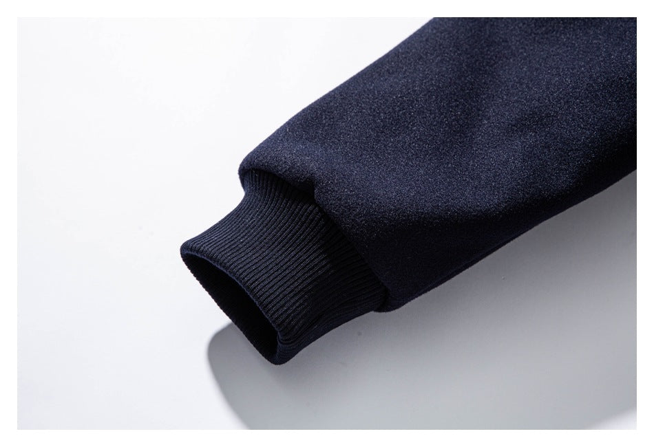 Close-up of a dark navy jacket sleeve ending in a black ribbed cuff.
