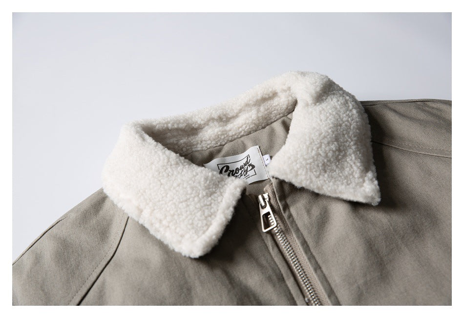 Close-up of the jacket's cream textured collar, zipper, and interior neck label.
