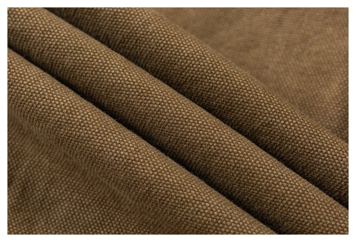 Close-up of brown textured fabric arranged in soft folds.