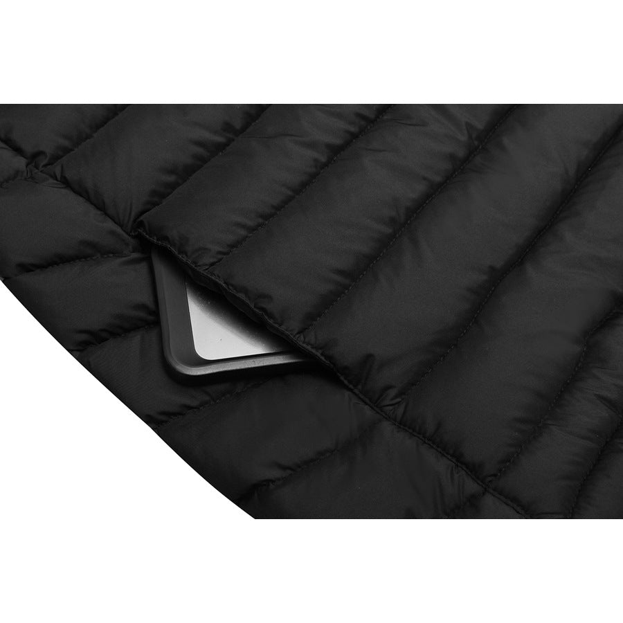 Close-up of the black jacket's quilted pocket area with a rectangular object tucked beneath a flap.