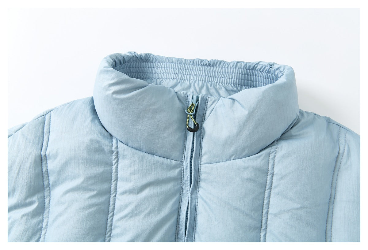 Close-up of a pale blue jacket's high stand collar, center zipper and contrasting cord zipper pull.