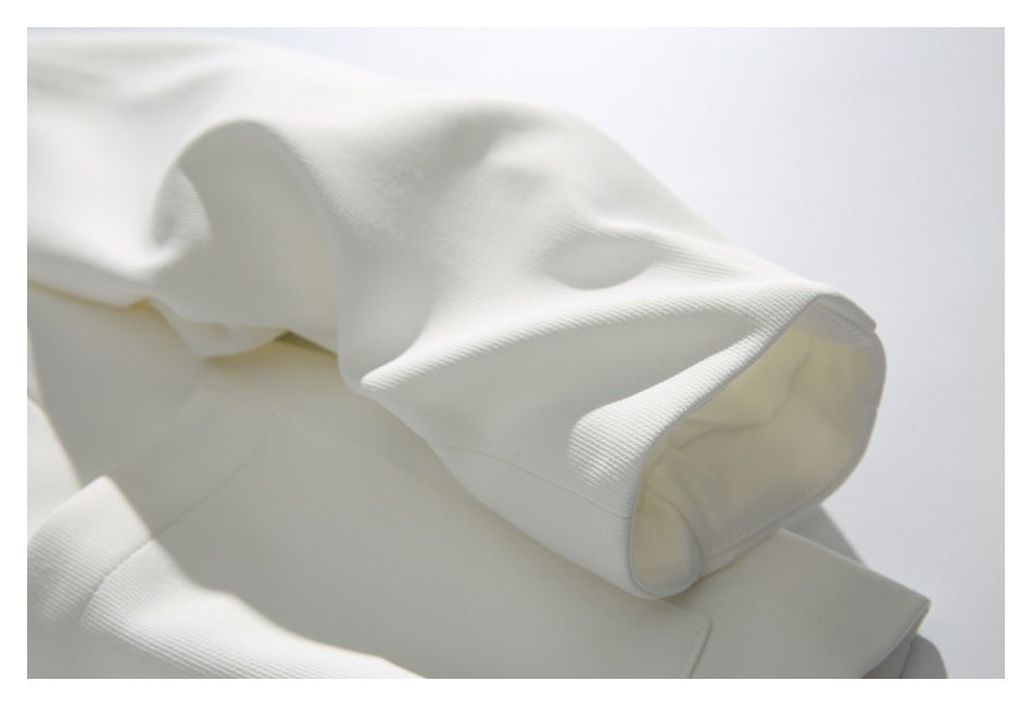 Close-up of the white jacket's long sleeve and cuff.