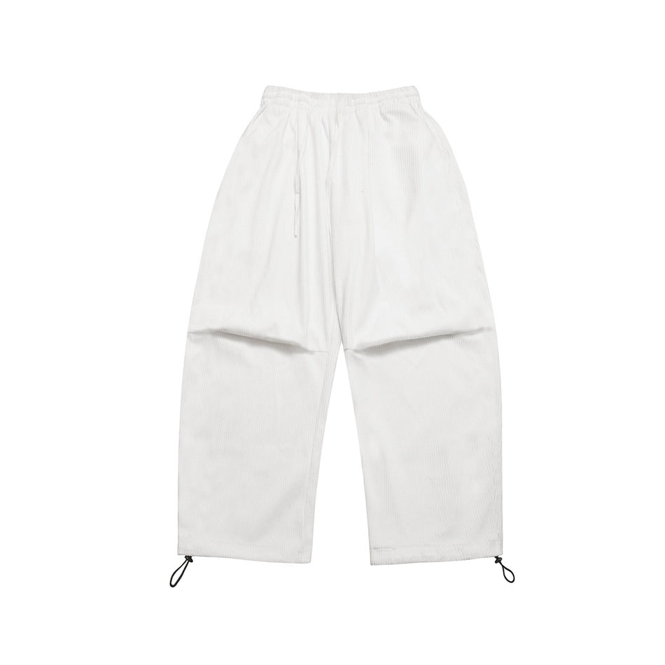 White ribbed wide-leg pants flat lay, front view, with drawstring waist and toggle hems