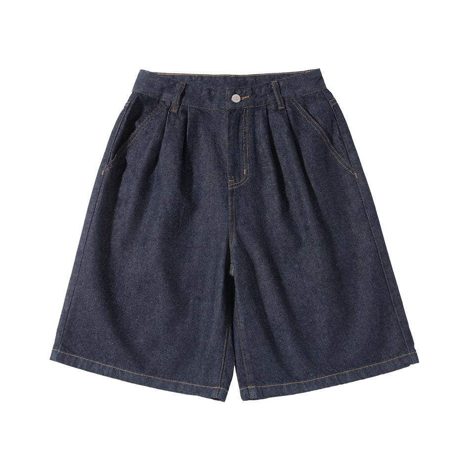 Dark indigo denim knee-length wide-leg shorts, front flat lay with pleats, zip fly, button and side pockets