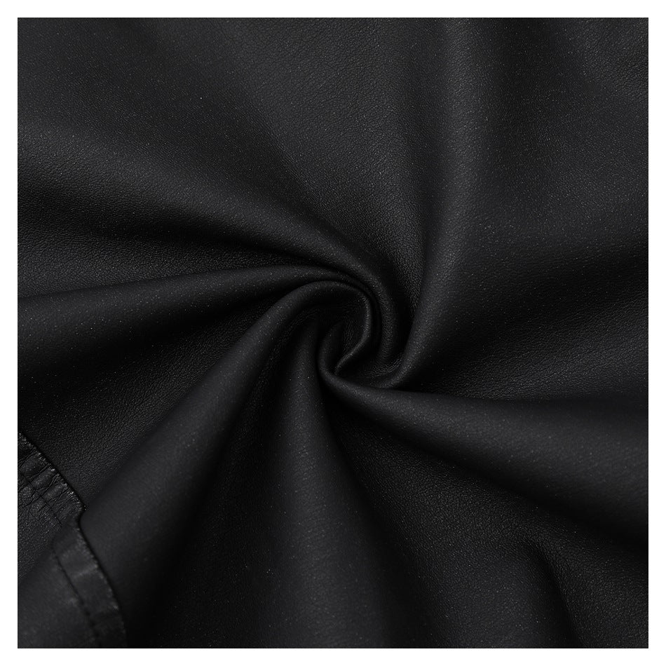 Close-up of black jacket material gathered into a spiral fold, showing its fine surface texture.