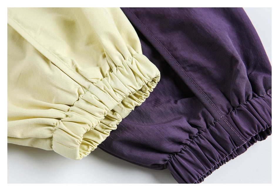 Close-up of gathered elastic cuffs on pale yellow and deep purple garments.