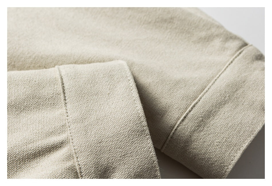 Close-up of a folded beige sleeve cuff and garment seam.