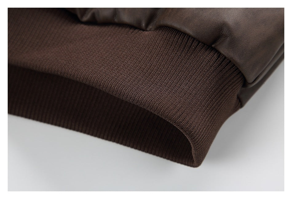 Close-up of the jacket's wide dark brown ribbed hem band.