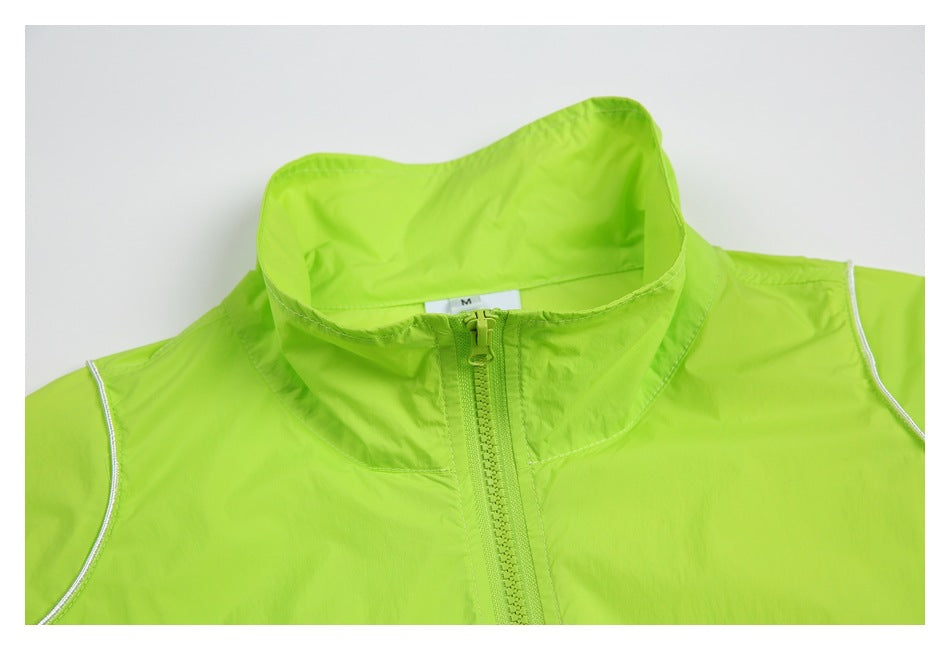 Close-up of a neon lime jacket's high collar, front zipper, white piping and size label.