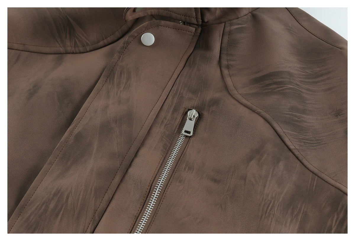 Close-up of a brown jacket's front panel, with a silver zipper pocket and snap-fastened flap.