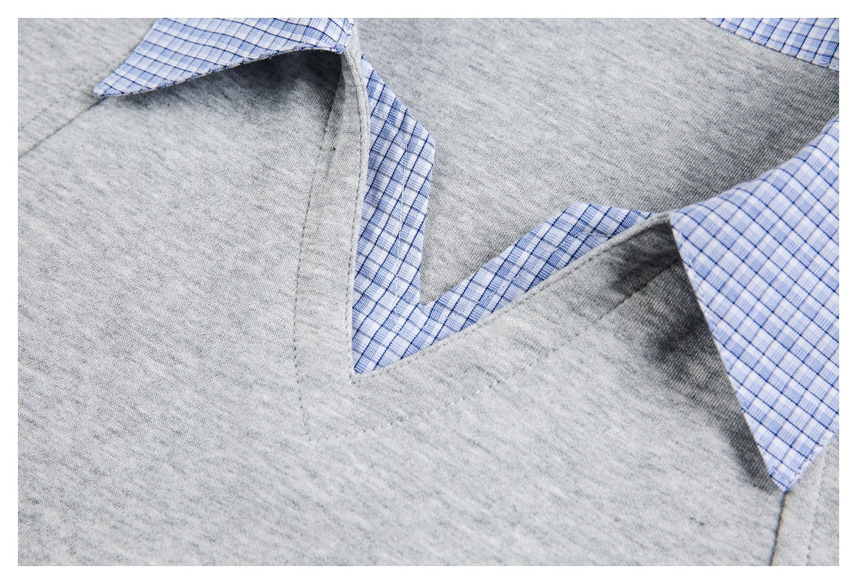 Close-up of the gray V-neck seam with blue checked fabric visible beneath the neckline.