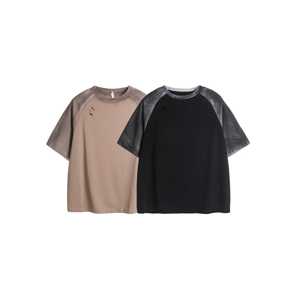Front view of taupe and black raglan T-shirts with washed charcoal sleeves and small distressed details.