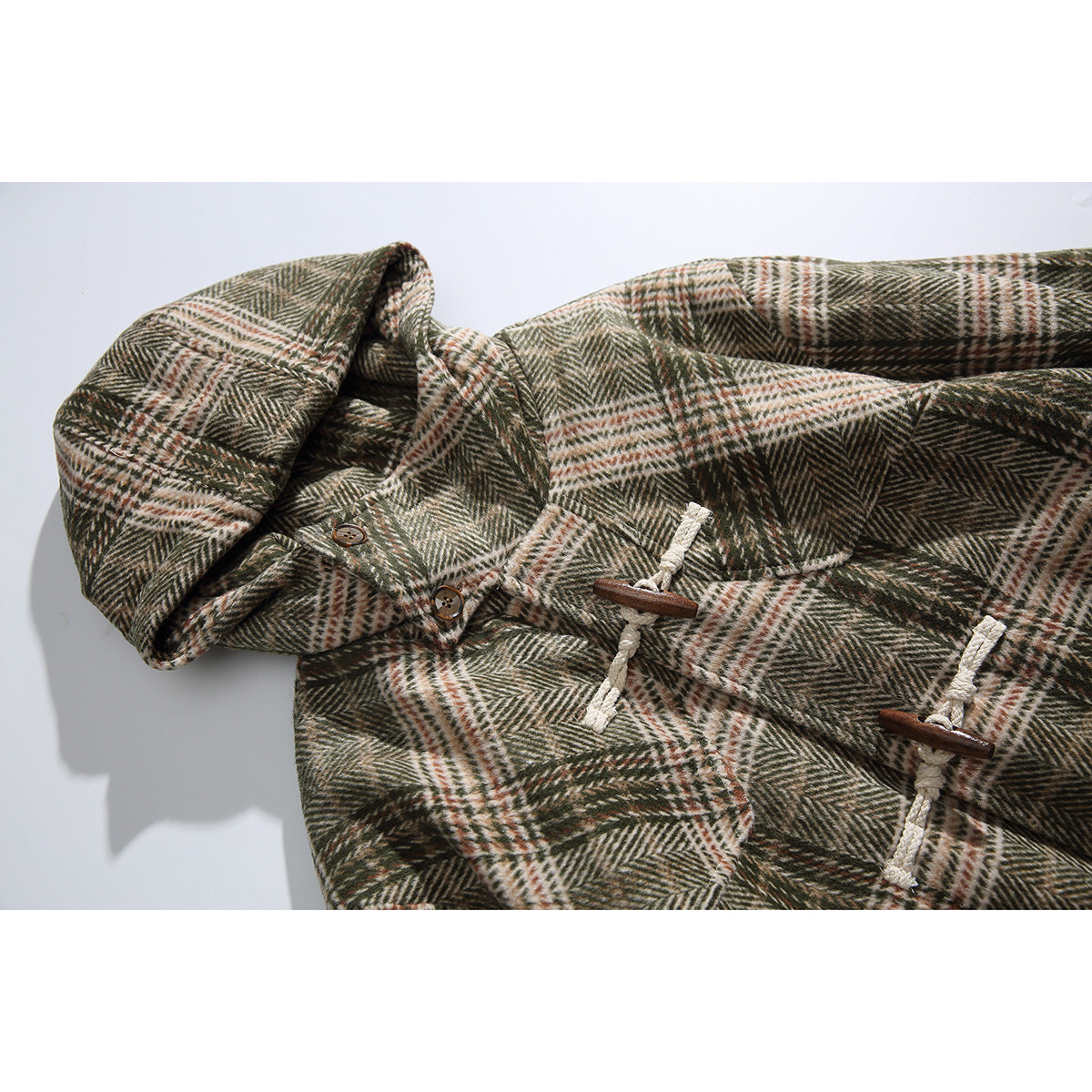 Close-up of the plaid jacket’s hood, collar buttons, and cream rope-and-wood toggle closures.