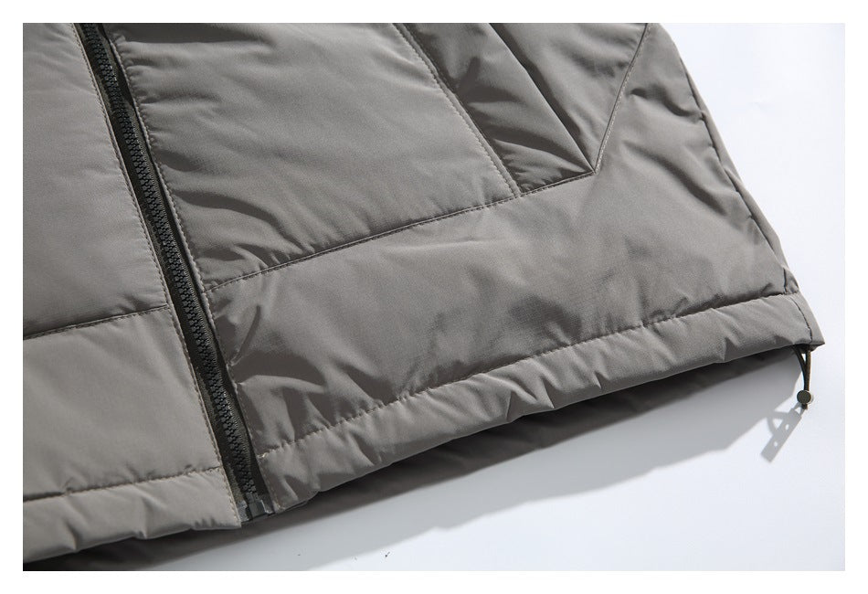 Close-up of the gray jacket hem, showing a black zipper, stitched panels, and an adjustable drawcord.