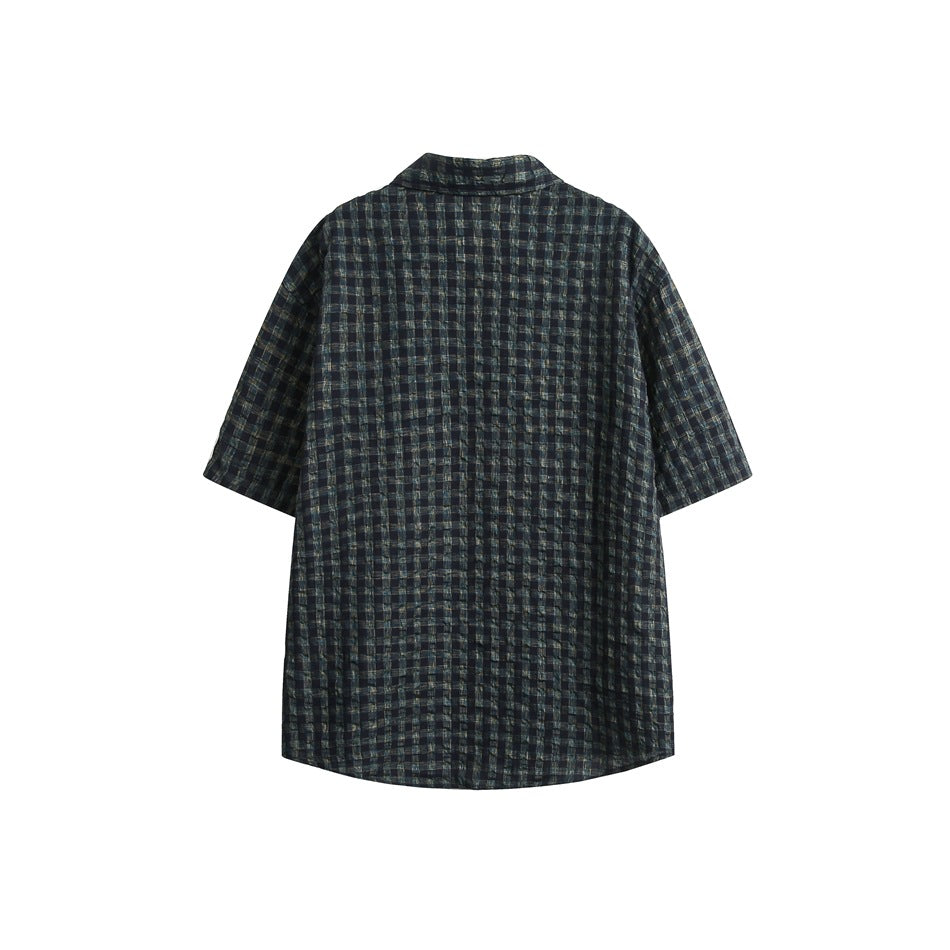 Back view of a dark navy and gray plaid short-sleeve button-up shirt on a white background.
