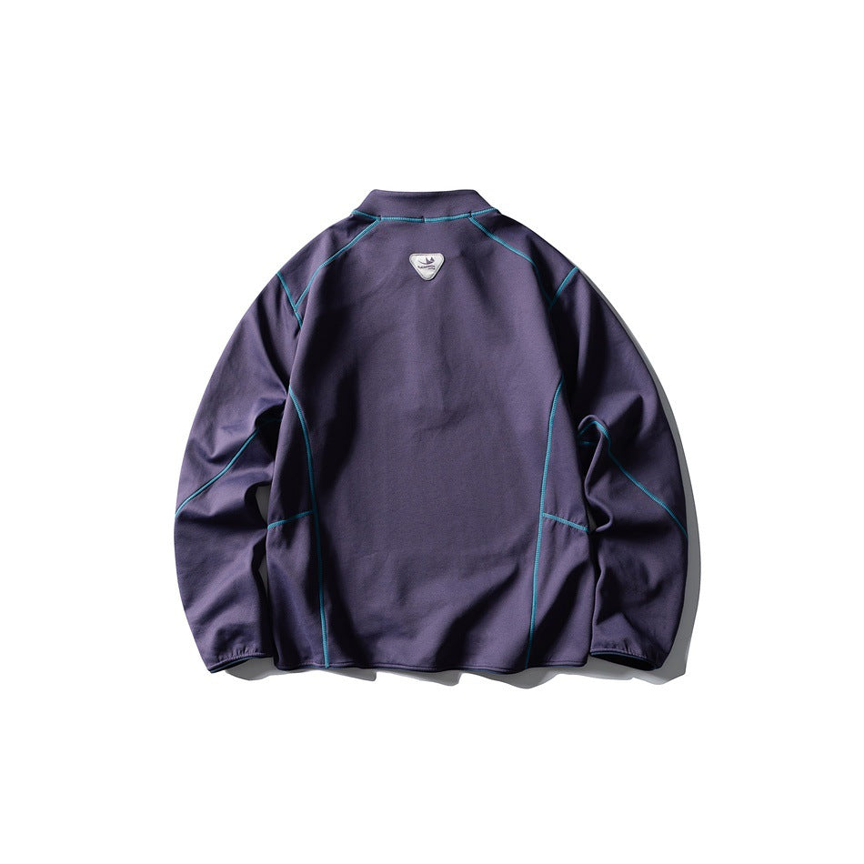 Back view of a dark purple long-sleeved top with bright teal seam piping and a small patch below the collar.