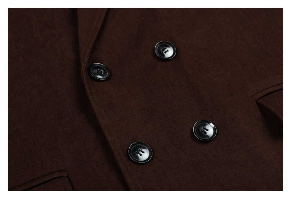 Close-up of a dark brown garment front with four glossy black buttons and partial welt pockets.