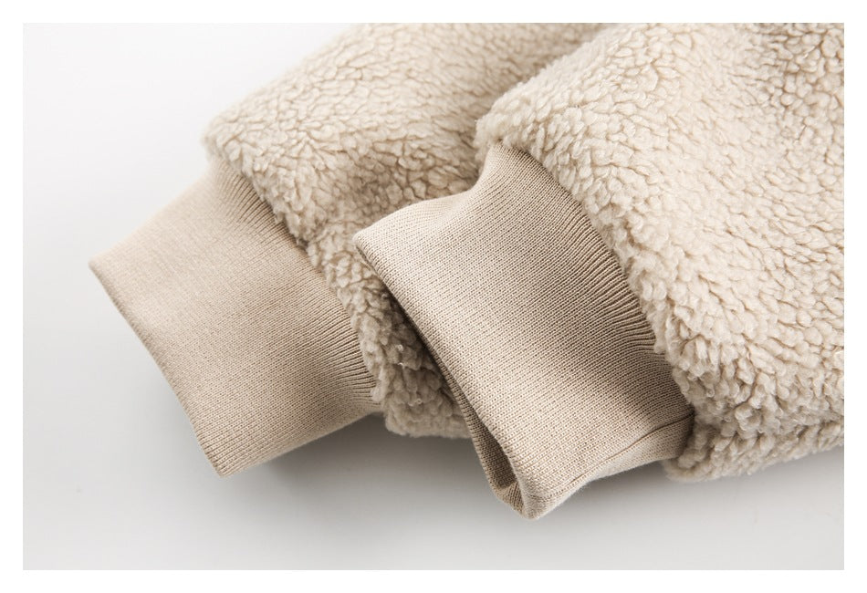 Close-up of light beige rib-knit cuffs on a plush jacket.