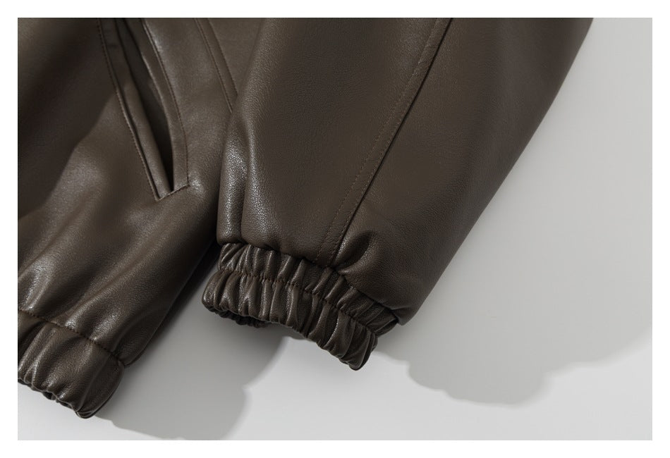 Close-up of a dark brown sleeve ending in a gathered elastic cuff.