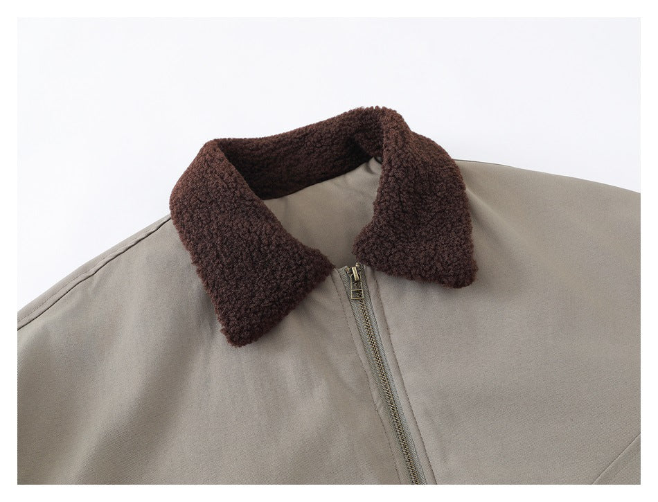 Close-up of the jacket's dark brown textured collar and brass-tone front zipper.
