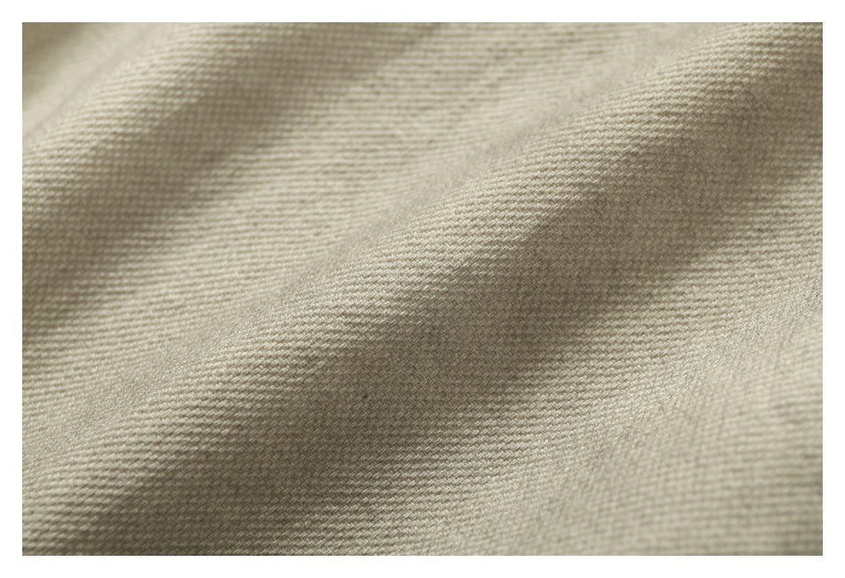 Extreme close-up showing the woven texture of beige fabric.