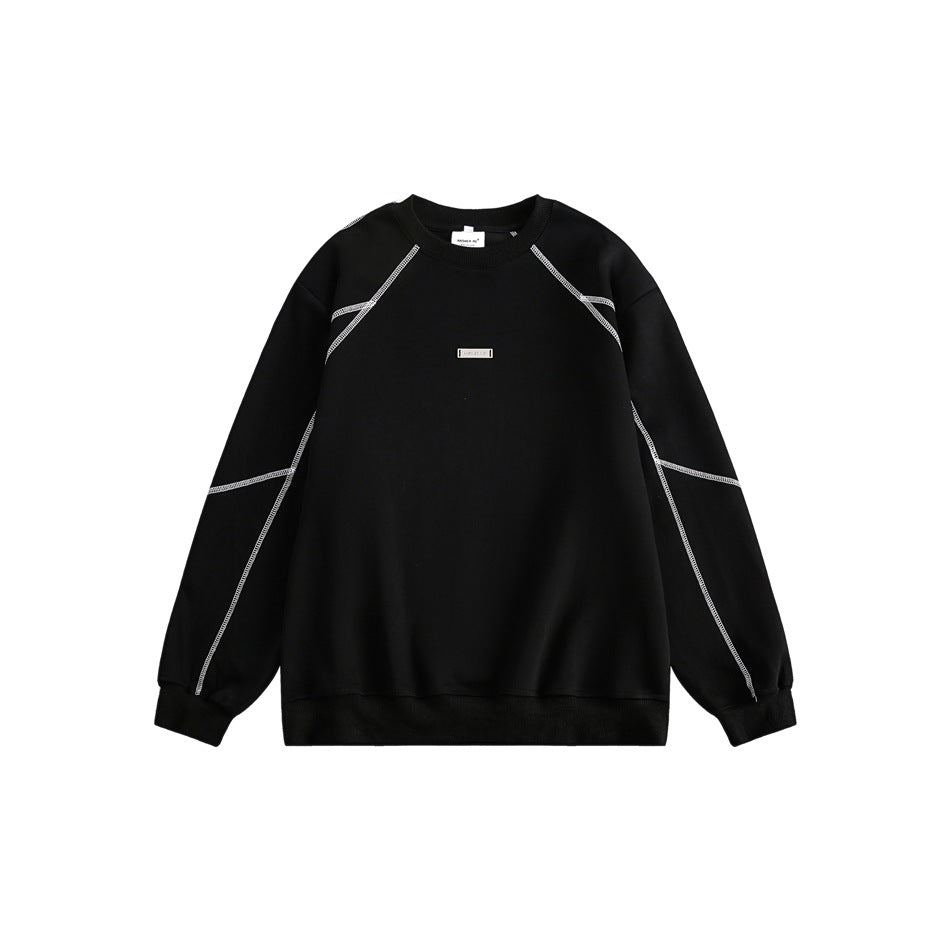 Black crew-neck sweatshirt with light contrast topstitching on raglan sleeves and a small metal plate on the chest