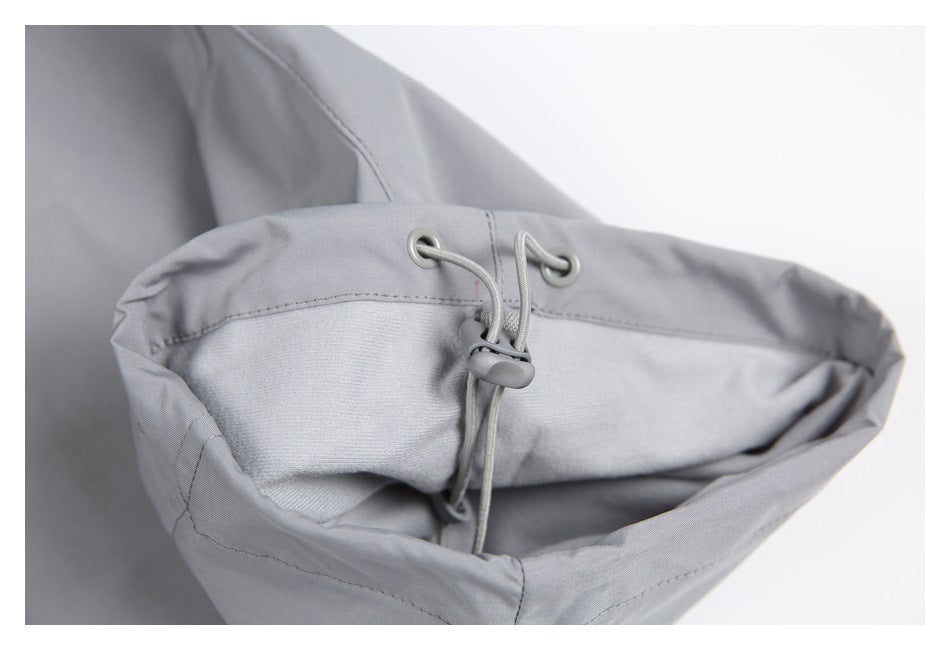 Close-up of a gray pant leg opening with a drawcord and toggle for adjustment.