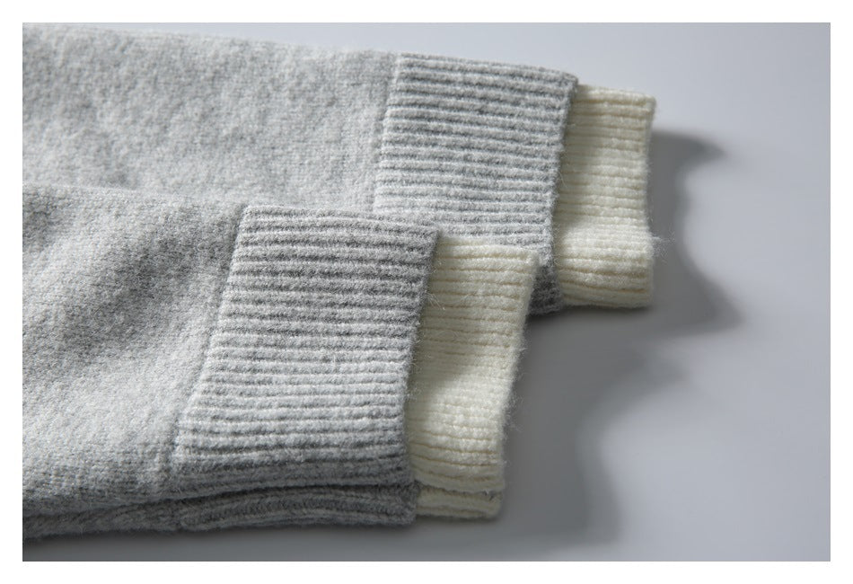 Close-up of gray and cream ribbed cuffs layered side by side.