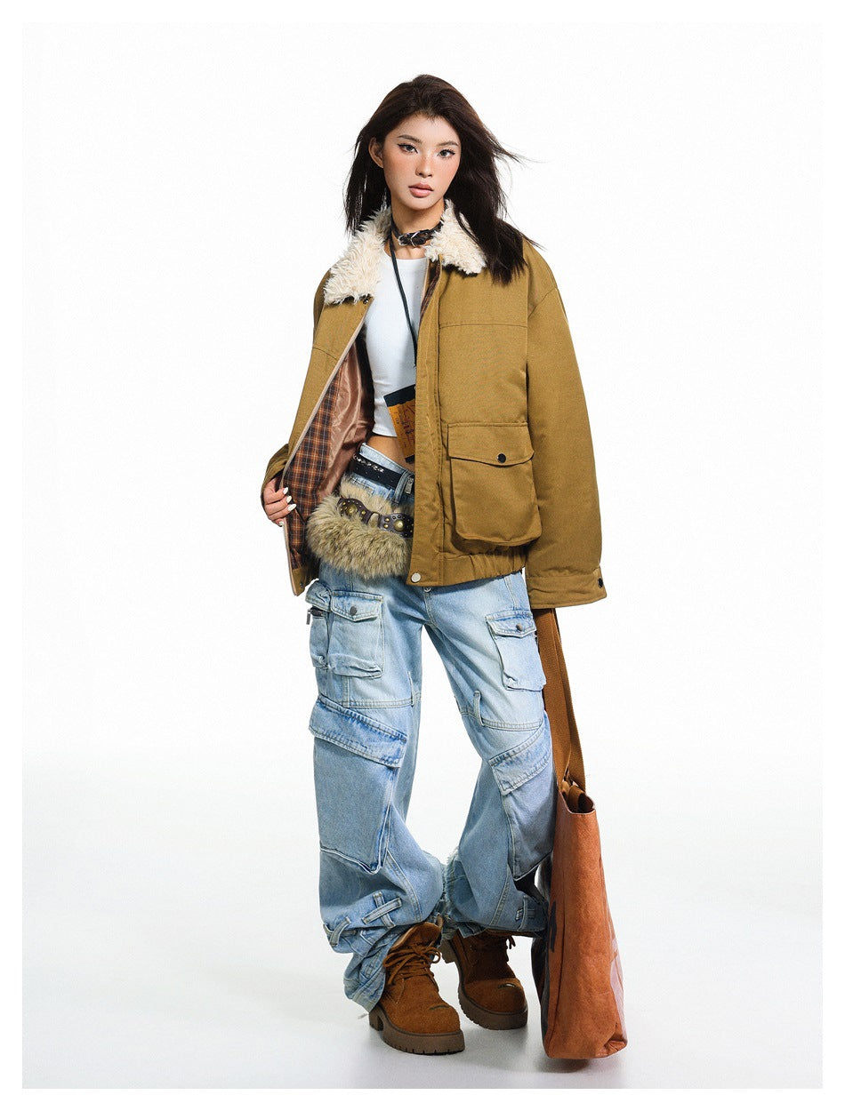 Model holding open an ochre jacket to show its plaid lining and cream faux-fur collar, worn with light-wash cargo jeans.