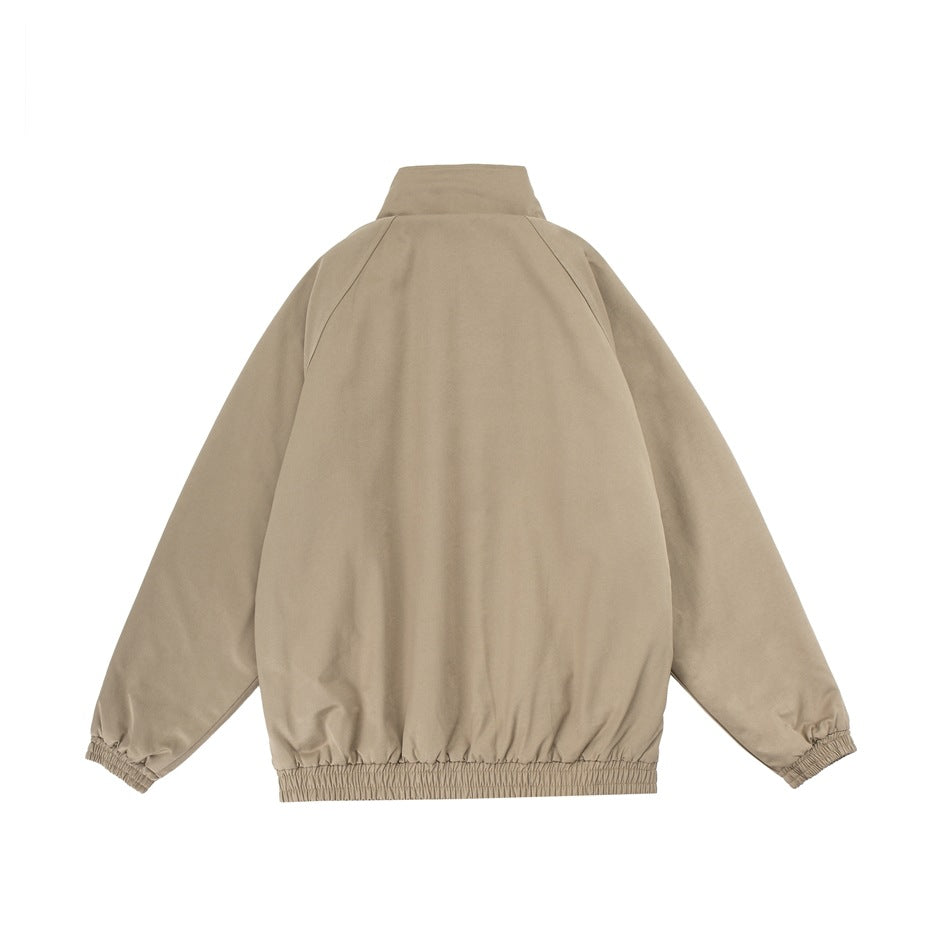 Back view of a beige jacket with a high collar, raglan sleeves, and elasticated cuffs and hem.