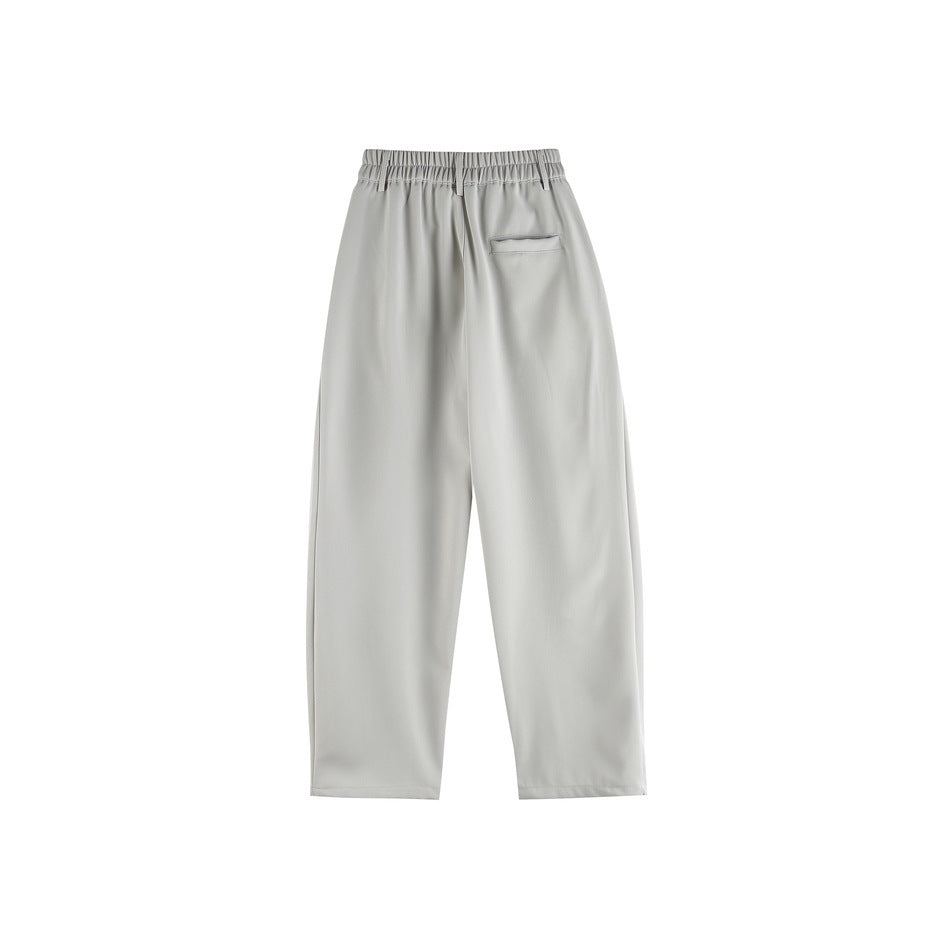 Back view of light gray wide-leg trousers with an elasticated waistband and a single back pocket.