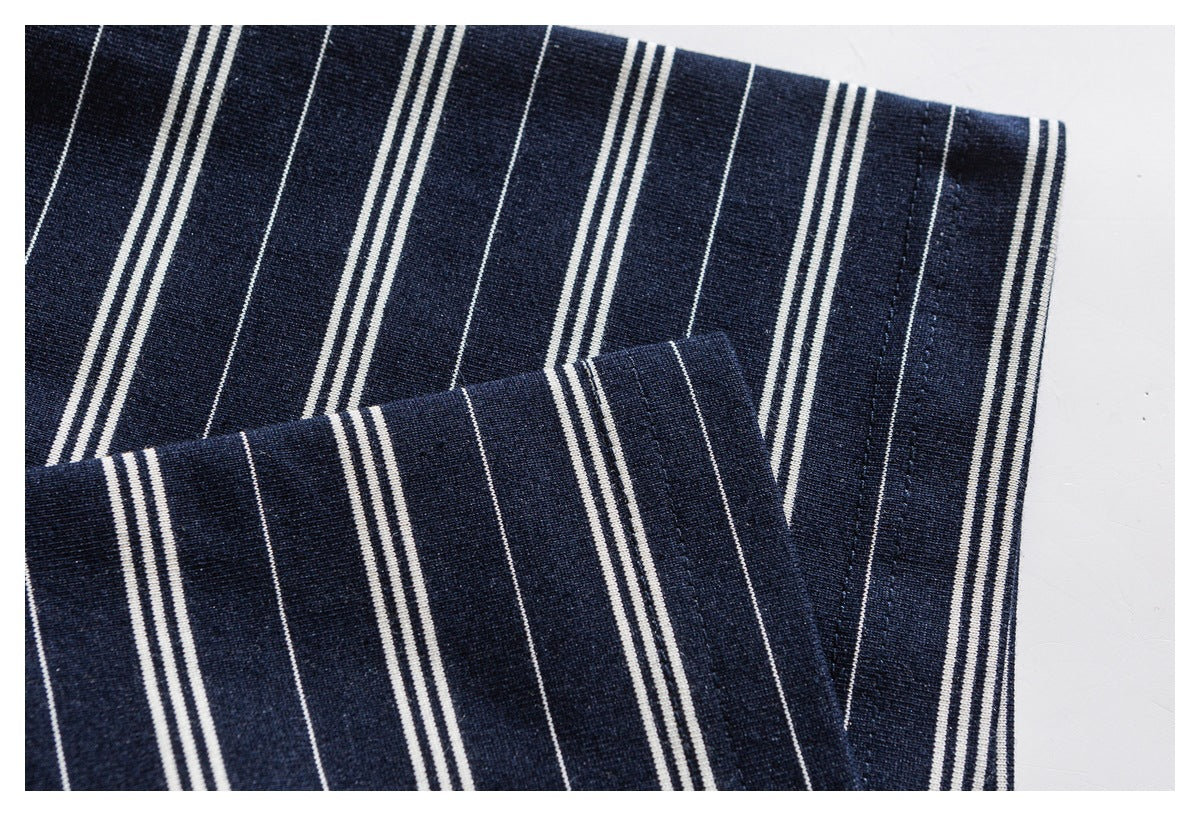 Close-up of a navy-and-white striped shirt sleeve and cuff.