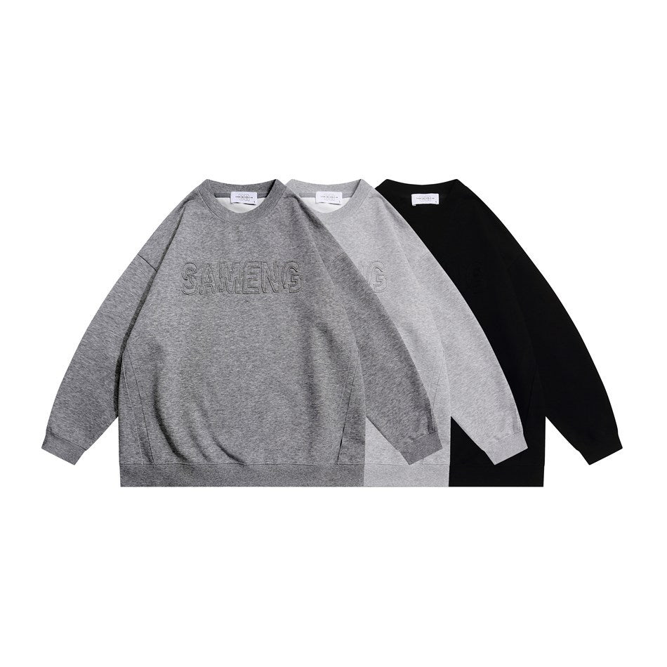 Three crewneck sweatshirts shown from the front in gray, light gray, and black; the gray one has outlined chest lettering.