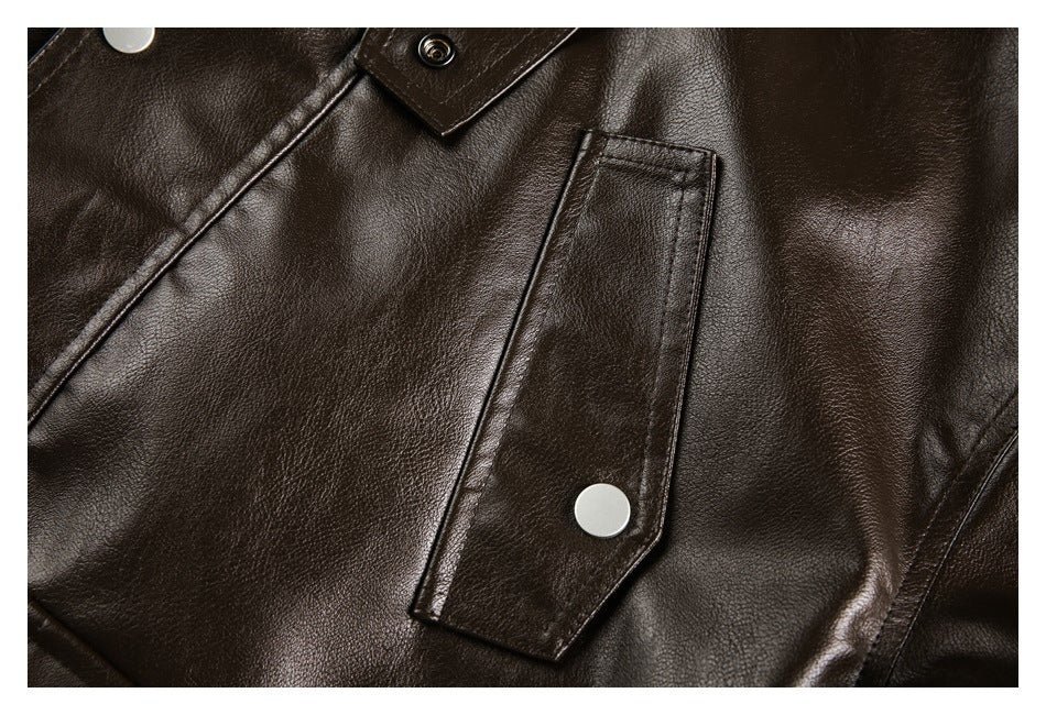Close-up of a dark brown jacket with a snap-button flap pocket and glossy pebbled finish.