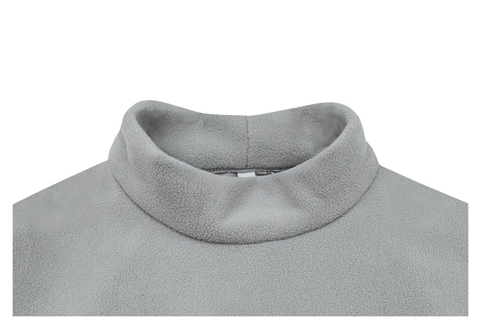 Close-up of the light gray fleece jacket's raised collar and upper chest.