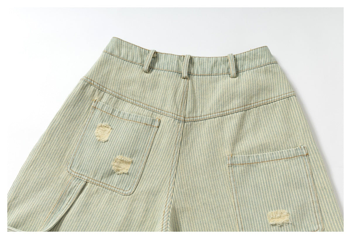 Back of pale blue and cream striped denim bottoms with belt loops and distressed patch pockets.